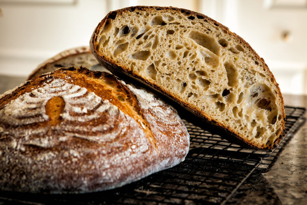 Sourdough bread with a thick crust and a cream-coloured crumb with irregular bubbles